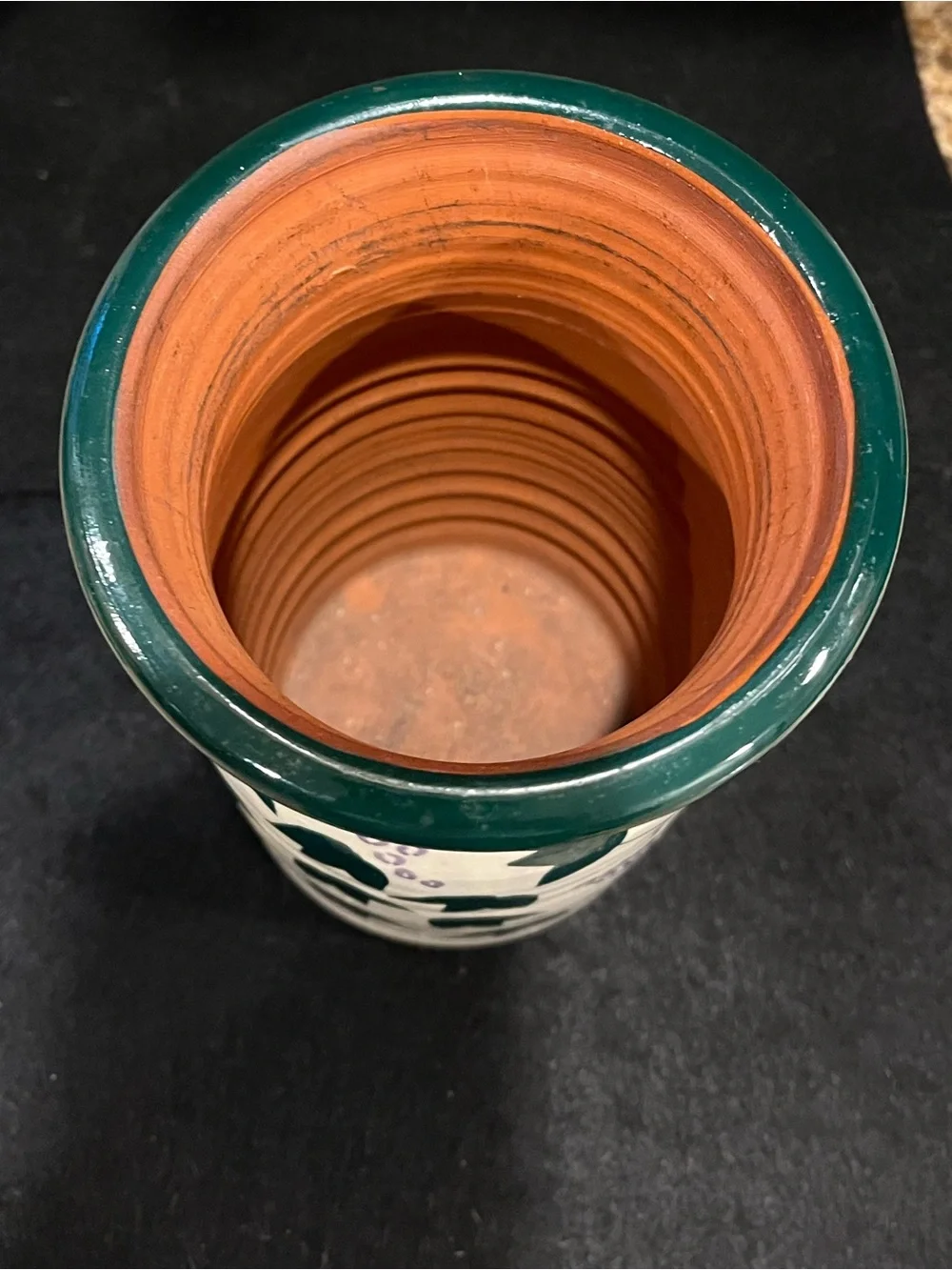 Handmade pottery vase cream-colored with a green and purple grape vine motif